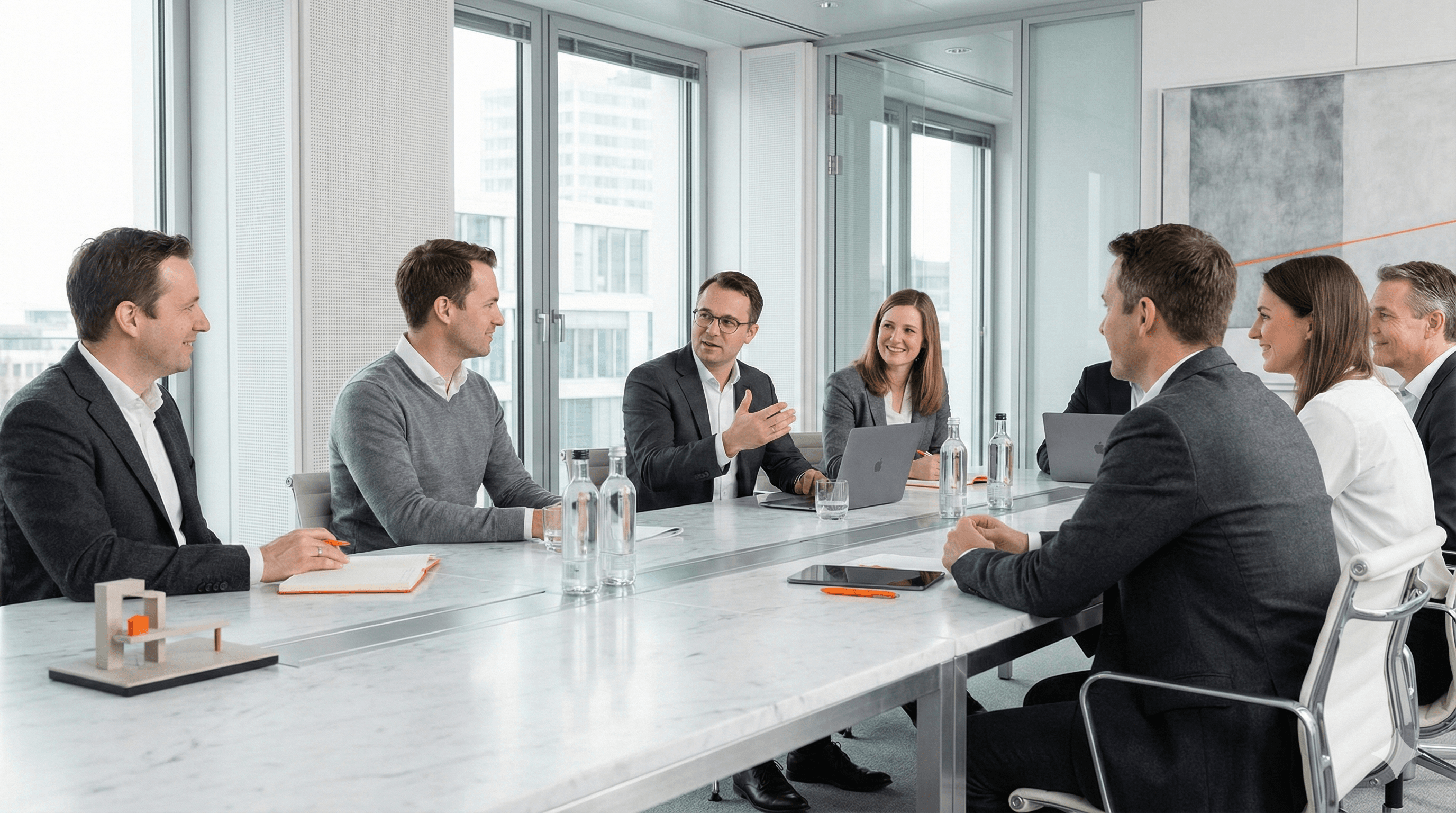 Business meeting around a large table in a bright conference room
