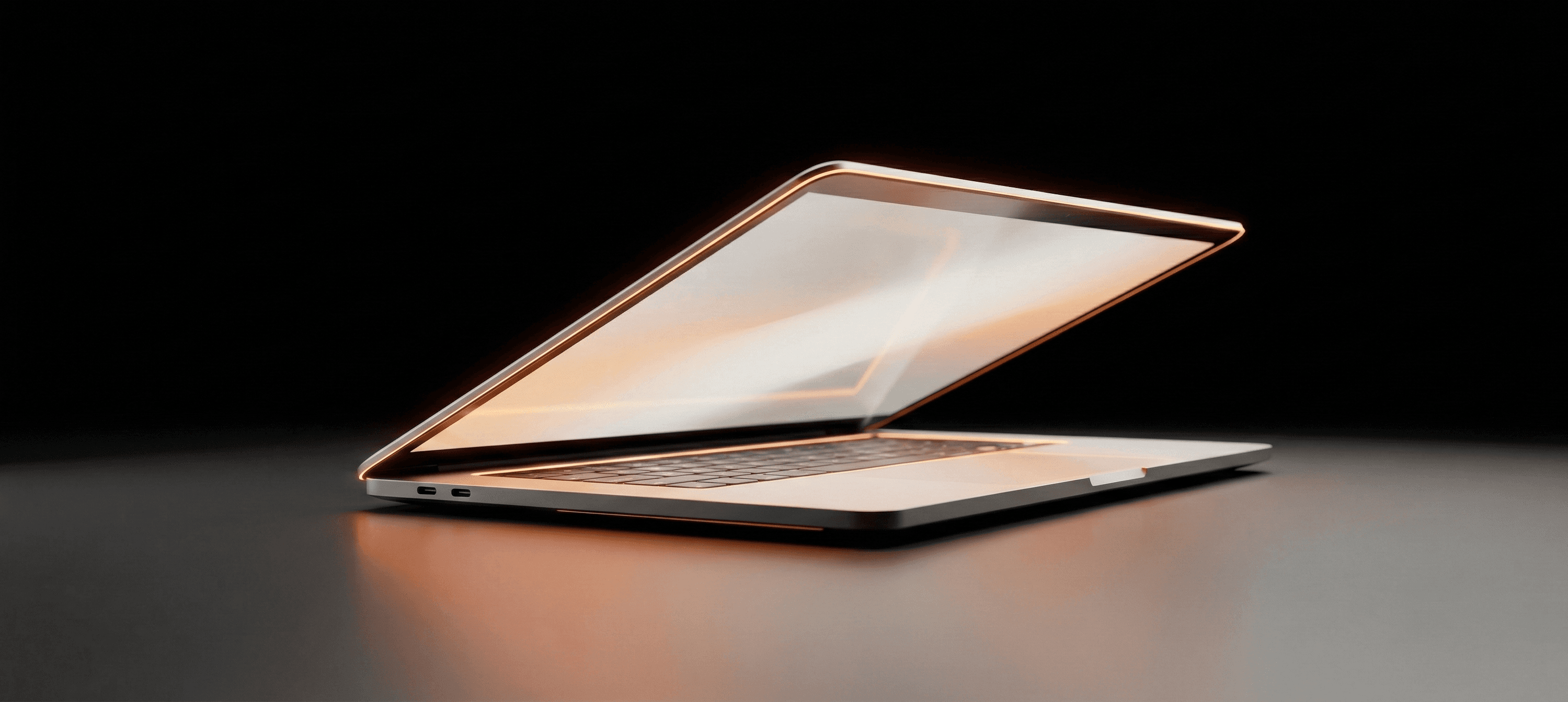 Open laptop with warm orange light on a dark background